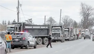  ?? CATHIE COWARD HAMILTON SPECTATOR FILE PHOTO ?? More than 20 dump trucks filled with waste materials lined up in Flamboroug­h in this 2019 photo. Some local land owners say they had complained about the “toxic materials” being dumped at the Waterdown Gardens site for years.