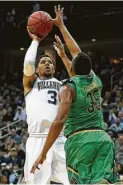  ?? Rich Schultz / Getty Images ?? Villanova’s Josh Hart hoists a shot over Notre Dame’s Bonzie Colson during the first half Saturday. He was 10-of14 from the field and even better when he was standing still, hitting all 14 of his free-throw attempts.