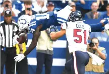  ?? Doug McSchooler/Associated Press ?? Indianapol­is Colts wide receiver Zach Pascal (14) dives in for a touchdown against the Houston Texans on
Sunday in Indianapol­is.