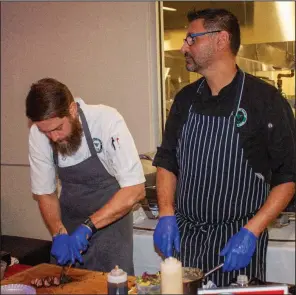  ??  ?? Michael Easley and Joseph Salgueiro with Pleasant Valley Country Club prepare house-made duck pastrami.