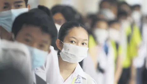  ??  ?? Students line up to sanitize their hands to avoid the coronaviru­s before their morning class at a high school in Phnom Penh, Cambodia, Jan. 28, 2020.