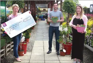  ??  ?? Eimear Mannion, CEO of St Aidan’s Services, receives a cheque for €3,500 – the proceeds of the Oakhill residents walk, run and cycle relay – from relay organisers Darren Burke and Katie Quinlan at St Aidan’s Garden Centre.