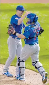  ?? MORRY GASH/AP ?? Alec Mills is congratula­ted by Cubs catcher Victor Caratini after completing his no-hitter against the Brewers on Sunday in Milwaukee.