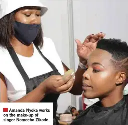  ??  ?? Amanda Nyoka works on the make-up of singer Nomcebo Zikode.