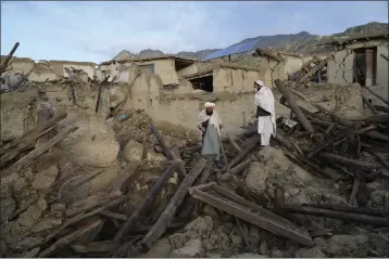  ?? EBRAHIM NOOROOZI — THE ASSOCIATED PRESS ?? Afghans stand among destructio­n after an earthquake in Gayan village in Paktika province, Afghanista­n, on Thursday.