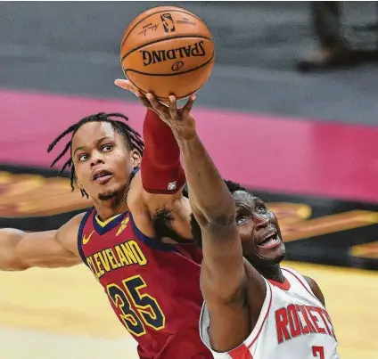  ?? Jason Miller / Getty Images ?? The Cavaliers’ Isaac Okoro, left, treats Victor Oladipo rudely in his return to the Rockets’ lineup. Oladipo had 17 points.