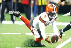  ?? Butch Dill/Associated Press ?? ■ Cleveland Browns quarterbac­k Tyrod Taylor (5) recovers his own fumble during the second half of an NFL game against the New Orleans Saints on Sunday in New Orleans.