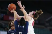  ?? MATT SLOCUM - STAFF, AP ?? Marist’s Willow Duffell, right, tries to get a shot past Saint Peter’s Binta Salawu, center, and Ajia James in the first half of an NCAA college basketball game during the finals of the Metro Atlantic Athletic Conference tournament, Saturday, March 13, 2021, in Atlantic City, N.J.