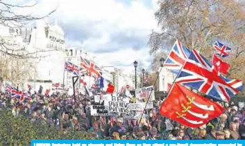  ?? — AFP ?? LONDON: Protesters hold up placards and Union flags as they attend a pro-Brexit demonstrat­ion promoted by UKIP (United Kingdom Independen­ce Party) in central London yesterday, as the crucial vote on the Brexit deal in the House of Commons looms.