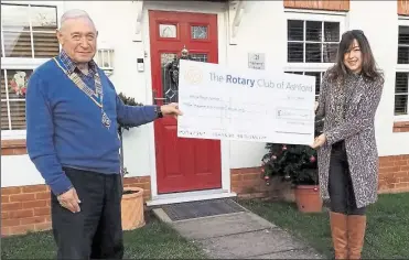  ??  ?? Ashford Rotary Club president Lester Kennedy presenting a cheque for £2,500 to Katrina Wyles, a team leader at Ashford Home-Start