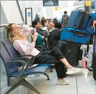  ?? AP ?? Frustrated passengers at JFK Airport await news about their flights that were cancelled or diverted due to the electrical fire at Terminal 1. Around 40 flights had been cancelled as of Friday, according to the Port Authority.