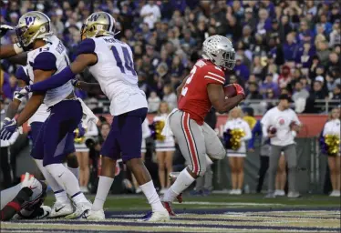  ?? MARK J. TERRILL — THE ASSOCIATED PRESS ?? Ohio State running back J.K. Dobbins scores against Washington during the second half of the Rose Bowl on Jan. 1 in Pasadena, Calif.