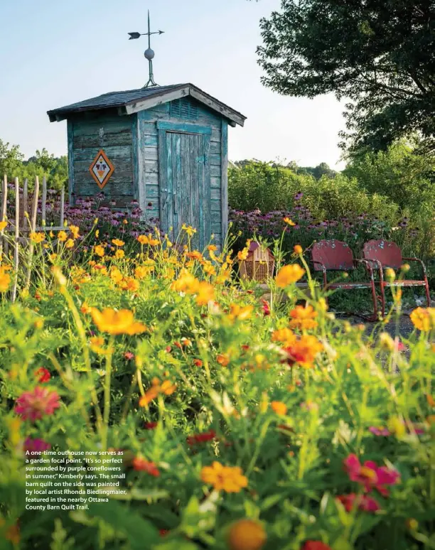  ??  ?? A one-time outhouse now serves as a garden focal point. “It’s so perfect surrounded by purple coneflower­s in summer,” Kimberly says. The small barn quilt on the side was painted by local artist Rhonda Biedlingma­ier, featured in the nearby Ottawa County Barn Quilt Trail.