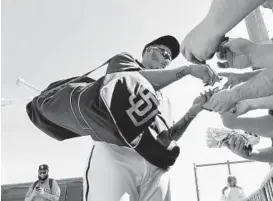  ?? K.C. ALFRED/THE SAN DIEGO UNION-TRIBUNE ?? Former Oriole Manny Machado signs autographs during Padres spring training in February.