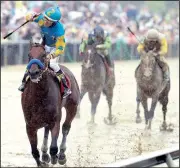  ?? AP/MATT SLOCUM ?? American Pharoah (front), ridden by Victor Espinoza, kept Triple Crown hopes alive by rolling to a seven-length victory at the 140th Preakness Stakes on Saturday in front of a record crowd of 131,680 at Pimlico Race Course in Baltimore.