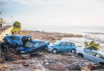  ?? JOAN MATEU PARRA/AP ?? Wrecked cars are stuck in the shore Thursday of the seaside town of Alcanar, in northeaste­rn Spain. A downpour Wednesday created flash floods that swept cars down streets in the Catalan town. Residents said Thursday that they were fortunate that no lives were lost when over 45 gallons per square yard of rain was dumped on the town Wednesday.