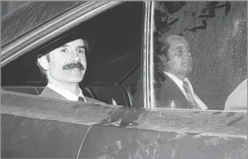  ?? Associated Press ?? NIXON ERA-INFAMY G. Gordon Liddy leaves a Los Angeles courthouse in 1973 after pleading innocent to charges of conspiracy and burglary. Later in life, he drove around Washington in a Volvo with license plates reading H2OGATE.