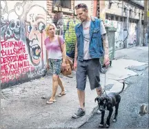  ?? CP PHOTO ?? Trey Helten, right, speaks with drug user Gina McEwen while walking his dog Princess Zelda in the Downtown Eastside of Vancouver on Friday.