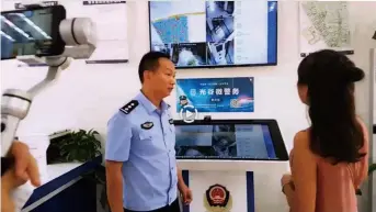  ??  ?? A still-image from a video live streamed at Douyu.com, in which Gu Na (right), Secretary of the online celebrity Party branch, visited a community police station in Wuhan, capital city of central China’s Hubei Province, on July 4