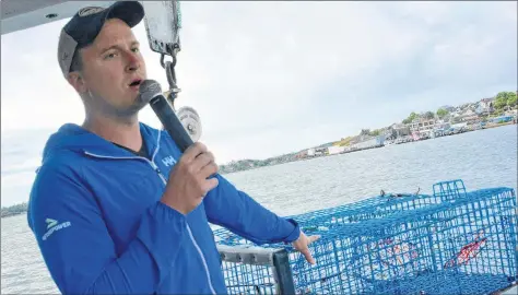  ??  ?? Lucien LeBlanc gives an explanatio­n about the lobster fishery.