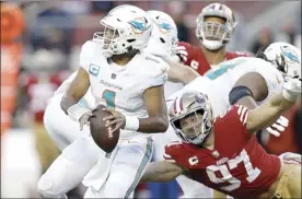  ?? AP file photo ?? Dolphins quarterbac­k Tua Tagovailoa looks to pass before 49ers defensive end Nick Bosa caused Tagovailoa to fumble during the second half on Dec. 4.