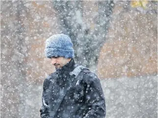  ?? TIM KROCHAK • THE CHRONICLE HERALD ?? Snow begins to fall on Barrington Street in Halifax on November 3. A powerful Nor'easter is expected to bring more snow to Nova Scotia on Thursday.