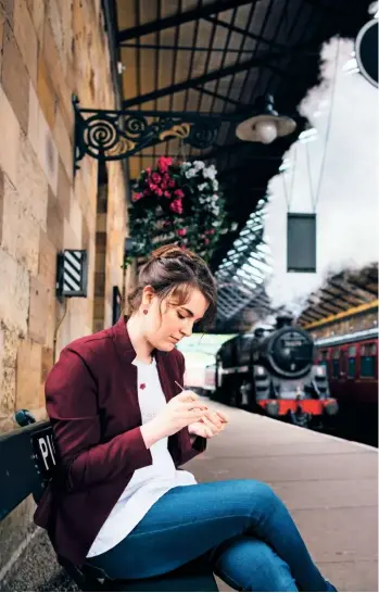  ??  ?? With a portable bag of tools and thread, Steffi can work anywhere she chooses. As she waits for a train at Pickering station, she stitches a tiny red flower.