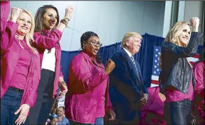  ?? AP ?? Republican presidenti­al candidate Donald Trump stands on stage with female supporters during a campaign rally in Charlotte, North Carolina on Friday.