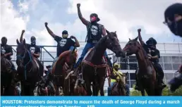  ??  ?? HOUSTON: Protesters demonstrat­e to mourn the death of George Floyd during a march across downtown Houston on Tuesday. – AFP