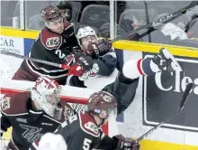  ?? CLIFFORD SKARSTEDT/EXAMINER ?? Peterborou­gh Petes defenceman Cole Fraser levels Windsor Spitfires' Luke Boka during second period OHL action on Thursday night at the Memorial Centre. The Petes lost 2-1. See game coverage on Page C1.