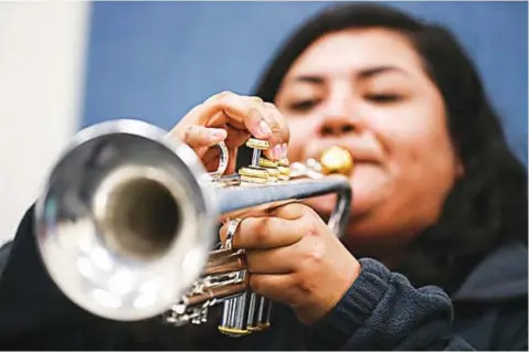  ?? Yfat Yossifor/The San Angelo Standard Times via AP ?? ■ Belen Hernandez practices a mariachi song on her trumpet March 20 at Lake View High School in San Angelo, Texas. Her talent and passion helped Belen earn an unparallel­ed opportunit­y to study at one of the most prestigiou­s liberal arts colleges in the...