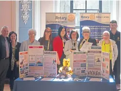  ??  ?? Members at their stand at the Rotary District 1010 assembly after being presented with the award.