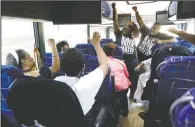  ??  ?? Black Voters Matter Fund co-founders, LaTosha Brown (left)and Cliff Albright (right) lead Mississipp­i grassroots partners in August 2018 in some empowermen­t cheers aboard a bus tour to Greenville, Miss.
(File Photo/AP/Rogelio V. Solis)