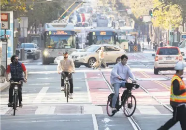  ?? Jessica Christian / The Chronicle ?? Plans for separate bicycle lanes in the Market Street redesign have been scrapped as a result of budget cuts.