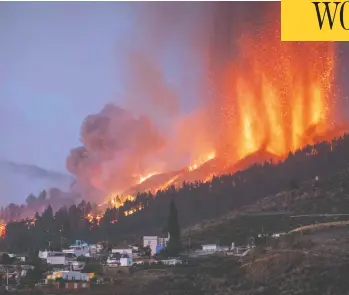  ?? DESIREE MARTIN/AFP VIA GETTY IMAGES ?? Mount Cumbre Vieja spewing out columns of smoke, ash and lava is seen from Los Llanos de Aridane on the Canary island of La Palma on Sunday, the volcano's first eruption since 1971.