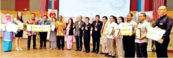  ??  ?? Hajiji (eighth left) and Dr Christina (seventh left) with the winners at the award ceremony yesterday.