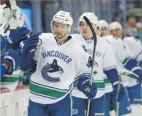  ?? PHOTOS: DAVID ZALUBOWSKI/THE ASSOCIATED PRESS ?? Vancouver Canucks left winger Sven Baertschi is congratula­ted as he passes his team’s bench after scoring a goal against the Colorado Avalanche in the first period on Wednesday night at the Pepsi Center in Denver.