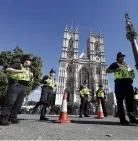  ?? PHOTO: REUTERS ?? Police officers keep watch outside Westminste­r Abbey in the leadup to the Queen’s funeral today.