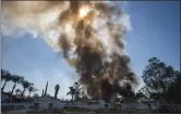  ?? WATCHARA PHOMICINDA — THE ORANGE COUNTY REGISTER ?? Smoke rises in the background after a fireworks stash exploded in Ontario on Tuesday.