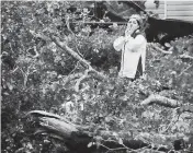  ?? JOE CAVARETTA South Florida Sun-Sentinel via AP ?? Broward County resident Zuram Rodriguez surveys the damage around her mobile home in Davie early Wednesday.