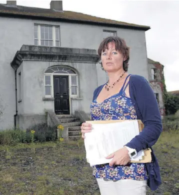  ??  ?? SHATTERED DREAMS: Jillian Godsil outside Raheengran­ey House near Shillelagh, Co Wicklow. The mother of two, whose house is being repossesse­d, said: ‘There is one law for rich Irish people and another for the poor.’ Photo: Frank McGrath