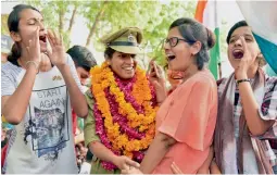  ?? — PTI ?? Tanushree Pareek, the first woman combat officer to be commission­ed in the 51-year history of the BSF, is received with full warmth by people in Bikaner on Sunday.