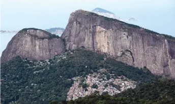  ??  ?? The Rocinha favela and the Dois Irmaos hill are seen from a hiking trail.