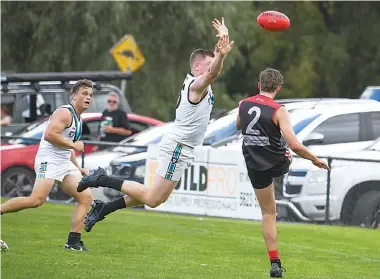  ?? ?? Gulls player Cooper Alger gets squeezed towards the boundary as his Wonthaggi opponent flies in for an attempted smother in the senior match.