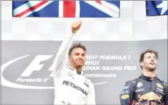  ?? AFP ?? Mercedes’ Lewis Hamilton (centre) celebrates on the podium after winning the Belgian Grand Prix on Sunday.