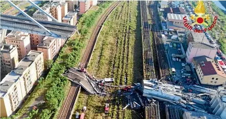  ?? AP ?? A bridge on a main highway linking Italy with France collapsed in the Italian port city of Genoa, sending vehicles plunging 90 metres.