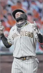  ?? Tony Avelar The Associated Press ?? The San Diego Padres’ Fernando Tatis Jr. points to the sky as he crosses home plate after hitting two-run home run Friday against San Francisco.