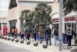  ??  ?? Shoppers keeping their distance on Wednesday