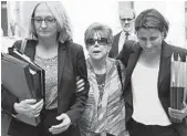  ?? MARK LENNIHAN/AP ?? Madeline Sayoc, center, mother of Cesar Sayoc, leaves court Monday after her son was sentenced to 20 years.