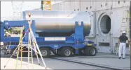  ?? Associated Press file photo / Dominion Resources ?? In this June 15, 2012 photo released by Dominion Resources, a spent fuel storage container is offloaded from a trailer into a horizontal storage module at the Millstone Power Station in Waterford. With the collapse of a proposal for nuclear waste storage at Nevadas Yucca Mountain, Millstone and other plants across the country are building or expanding on-site storage for waste.